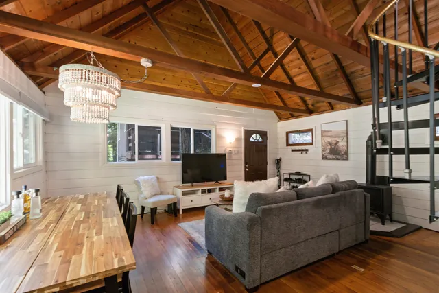 a living room with furniture wooden floor and a table