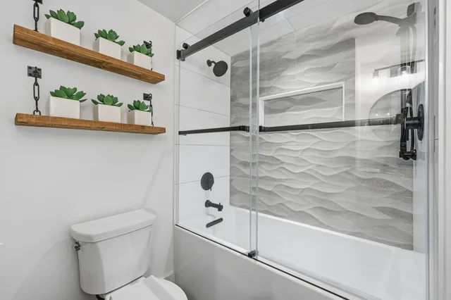 a bedroom with a bed and painting on the wall