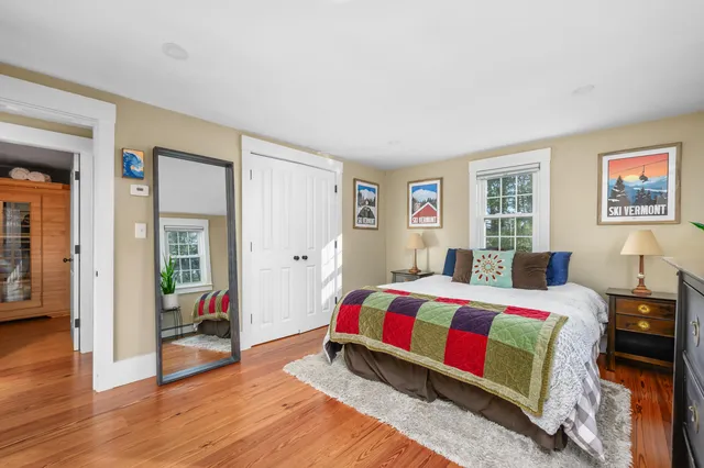 a bed room with a bed and a wooden floor