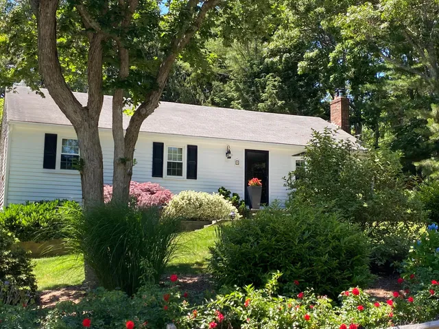 a front view of a house with a yard garage and outdoor seating