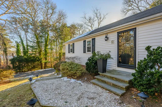 a view of a house with backyard and sitting area
