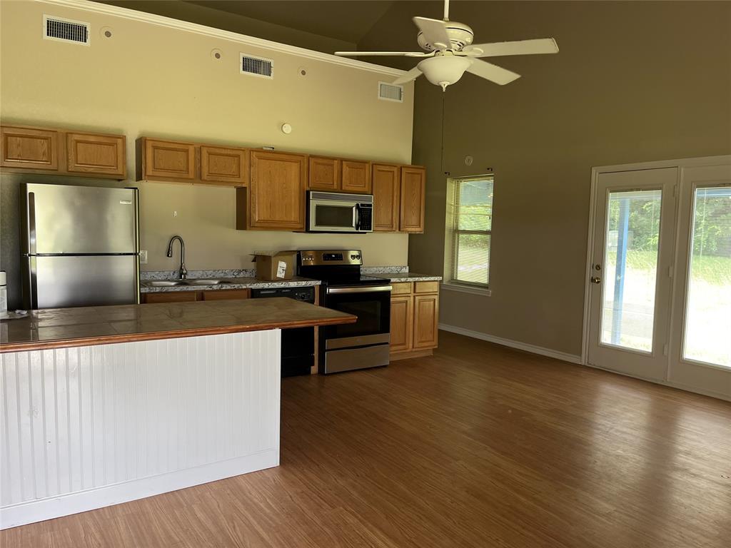3841 Ledgestone Lane Midlothian, TX 76065 - Photo 4 of 26 a kitchen with stainless steel appliances granite countertop a sink a stove top oven a counter space and cabinets