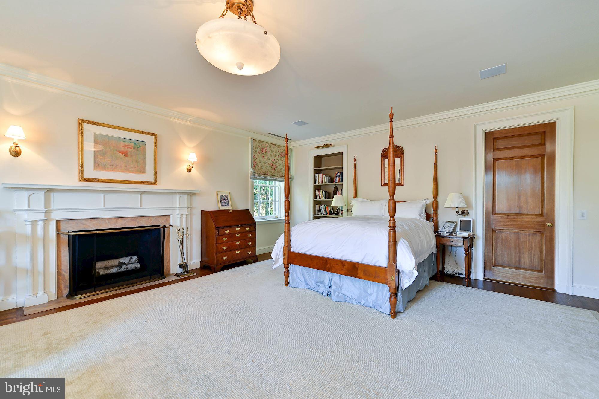1901 24th Street Northwest Washington, DC 20008 - Photo 14 of 27 a spacious bedroom with a bed and a fireplace