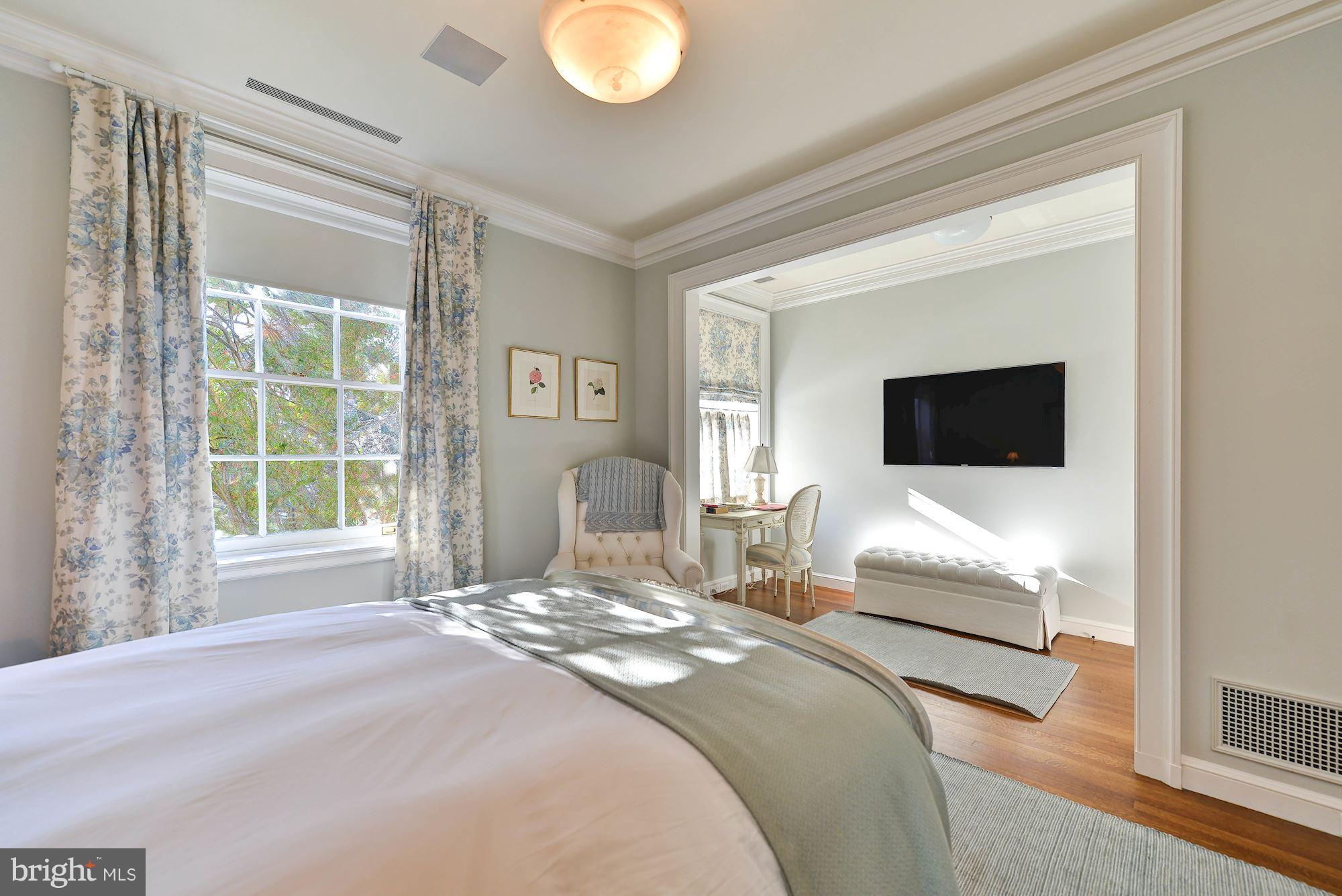1901 24th Street Northwest Washington, DC 20008 - Photo 21 of 27 a spacious bedroom with a bed and a flat tv screen