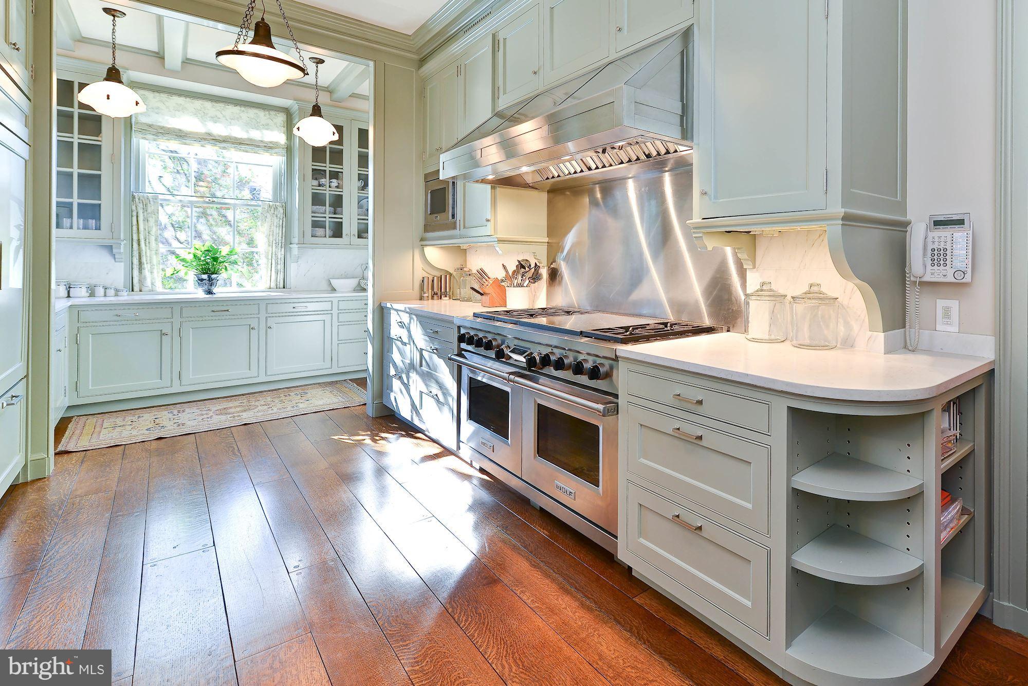 1901 24th Street Northwest Washington, DC 20008 - Photo 9 of 27 a kitchen with a stove and a wooden floor