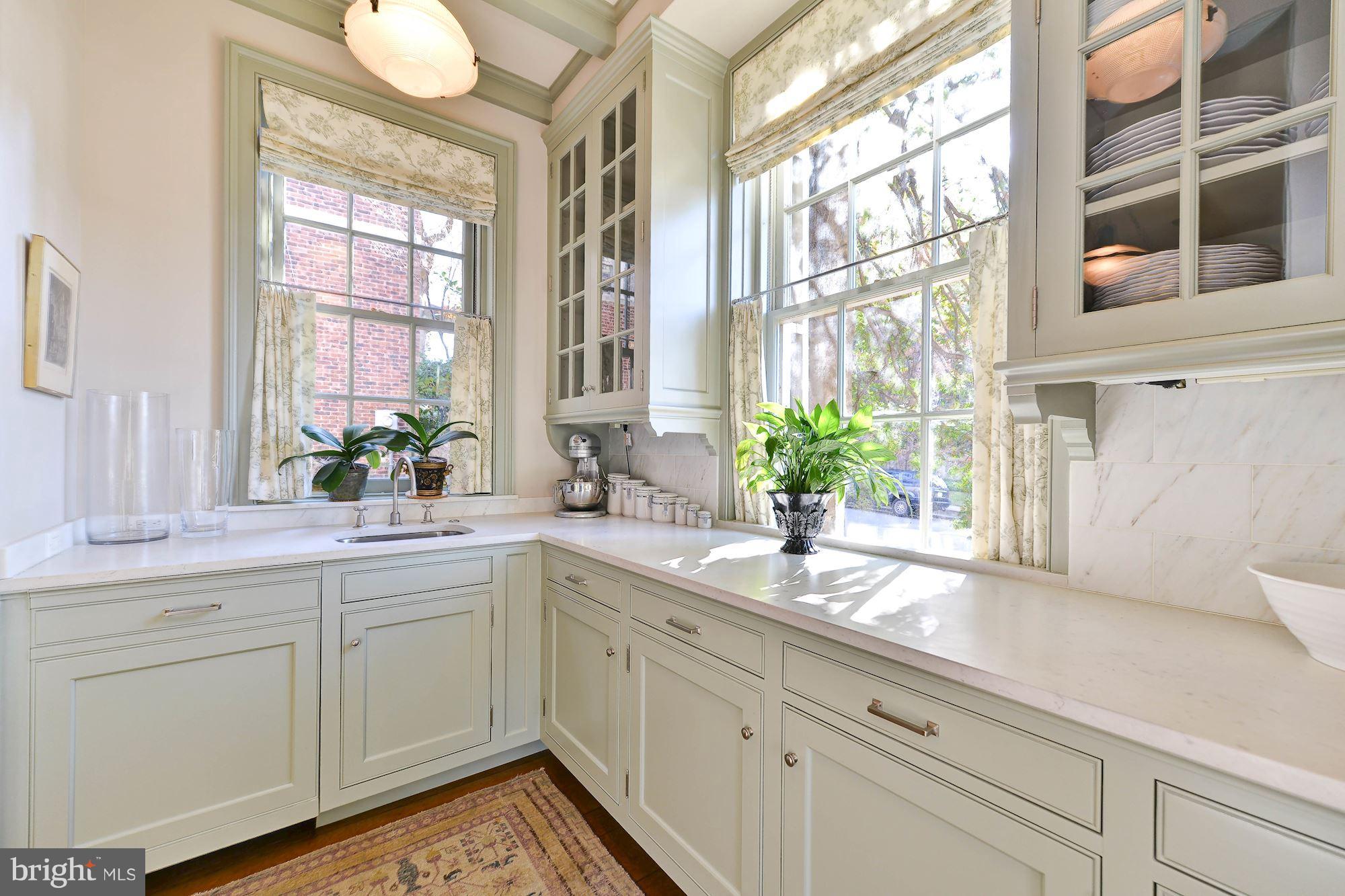 1901 24th Street Northwest Washington, DC 20008 - Photo 10 of 27 a kitchen with white cabinets and a window