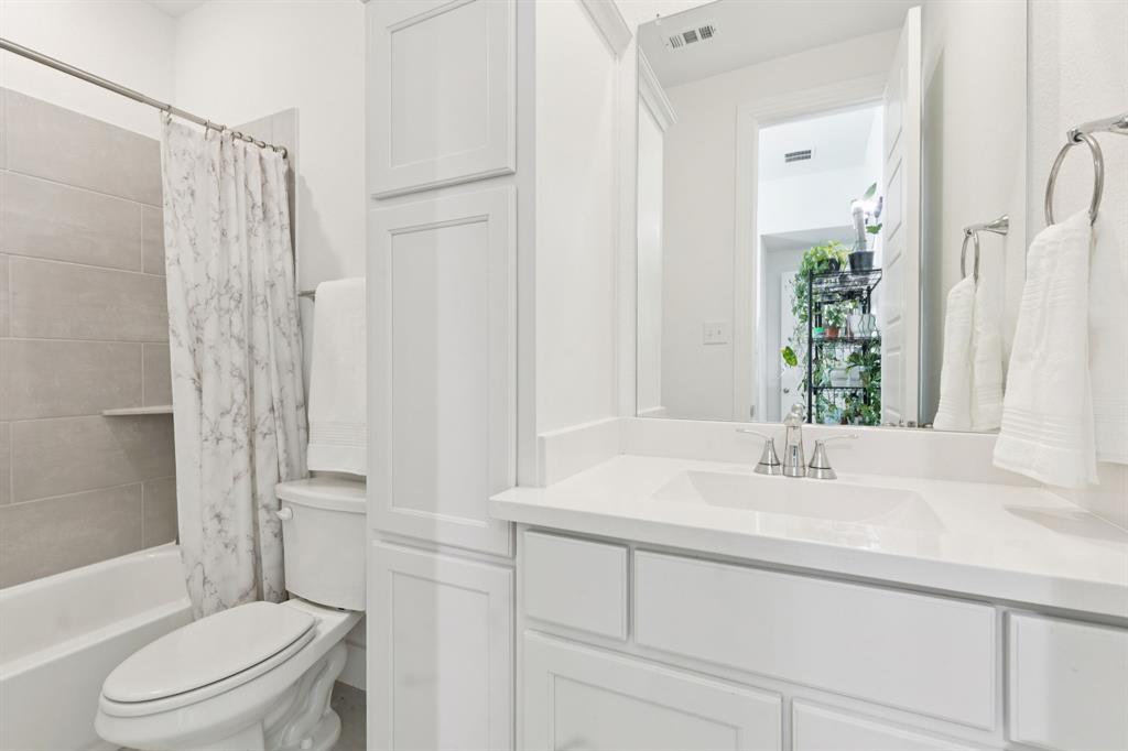 1903 Midhurst Drive Forney, TX 75126 - Photo 17 of 31 a bathroom with a sink a toilet and shower