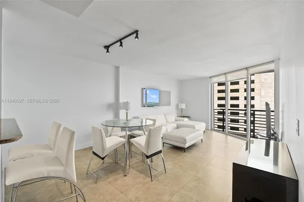 a bedroom with furniture and a window