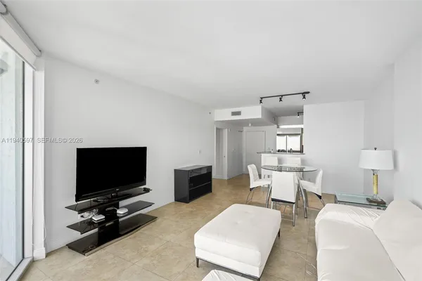 a living room with furniture and a flat screen tv