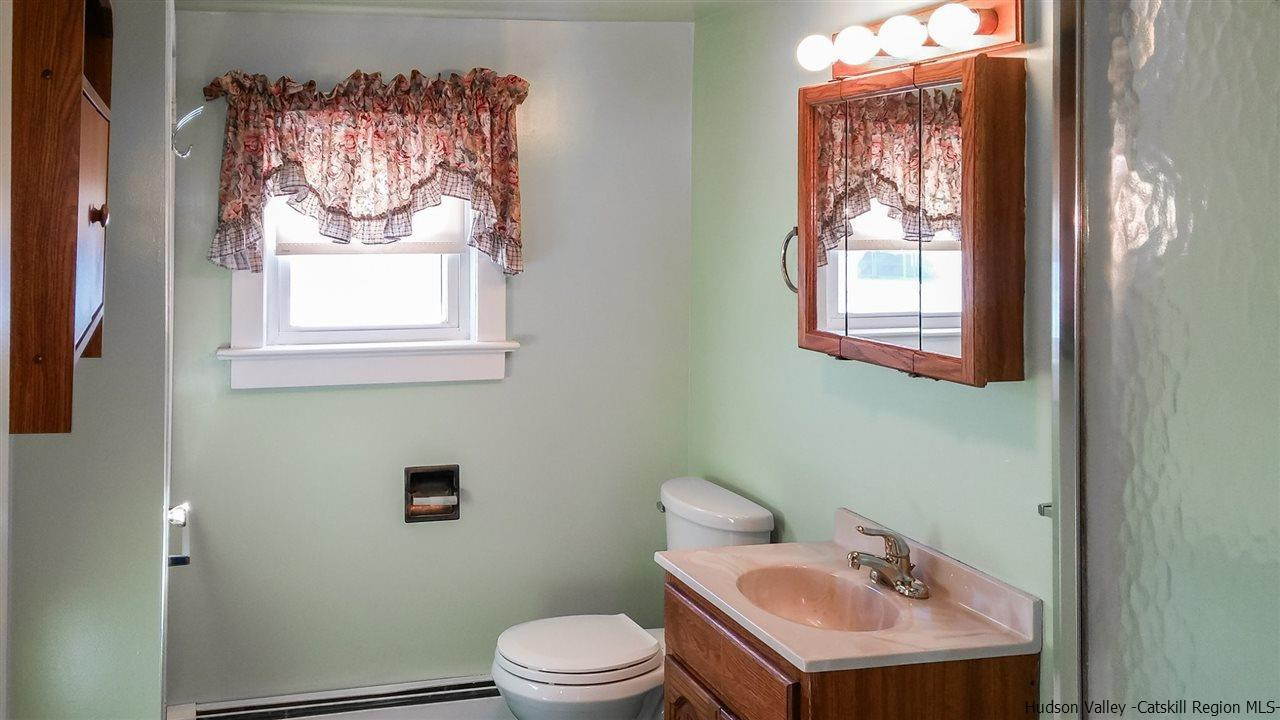 735 Springtown Road Tillson, NY 12486 - Photo 12 of 35 a bathroom with a sink mirror and a toilet