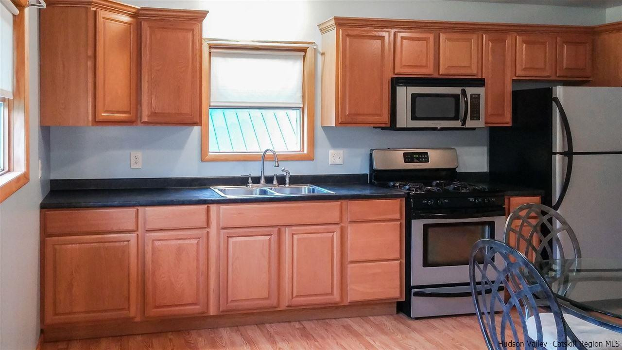 735 Springtown Road Tillson, NY 12486 - Photo 17 of 35 a kitchen with stainless steel appliances granite countertop a stove a sink and a microwave