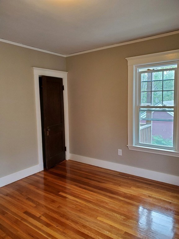 22 Allen Street, Unit 2 Arlington, MA 02474 - Photo 13 of 25 a view of an empty room with wooden floor and a window
