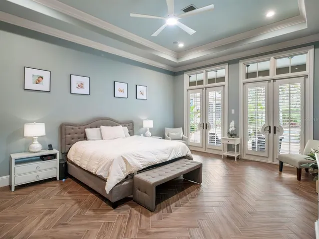 a spacious bedroom with a large bed and a flat screen tv