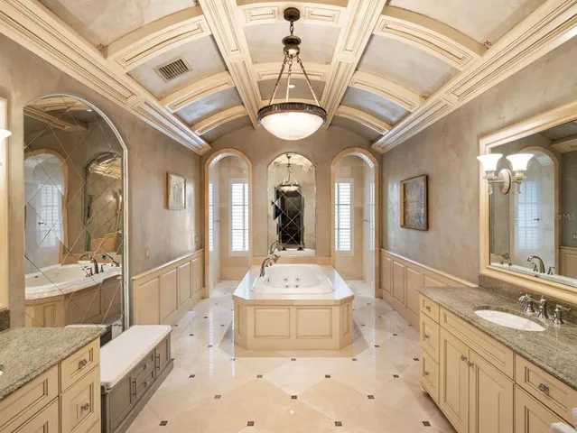 a bedroom with a bed and a flat tv screen on dresser