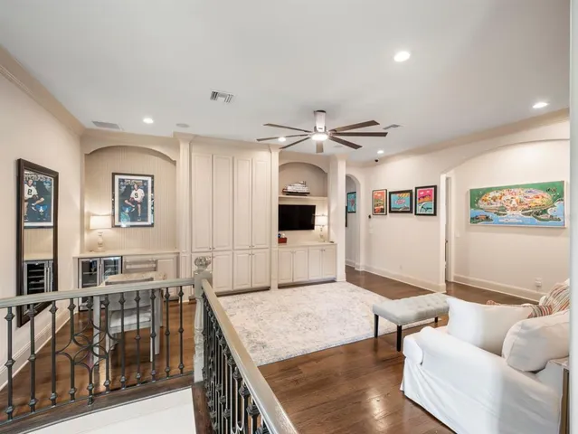 a bedroom with a bed chandelier and a window