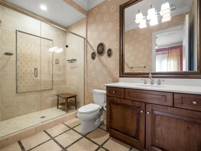 a bedroom with a bed wooden floor and chandelier