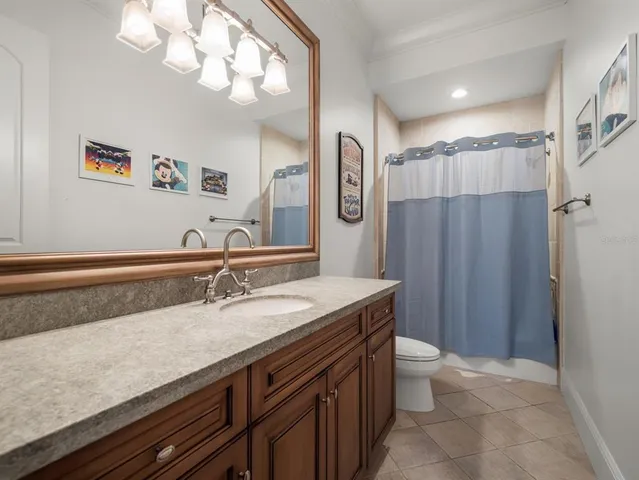a bedroom with two beds and a chandelier