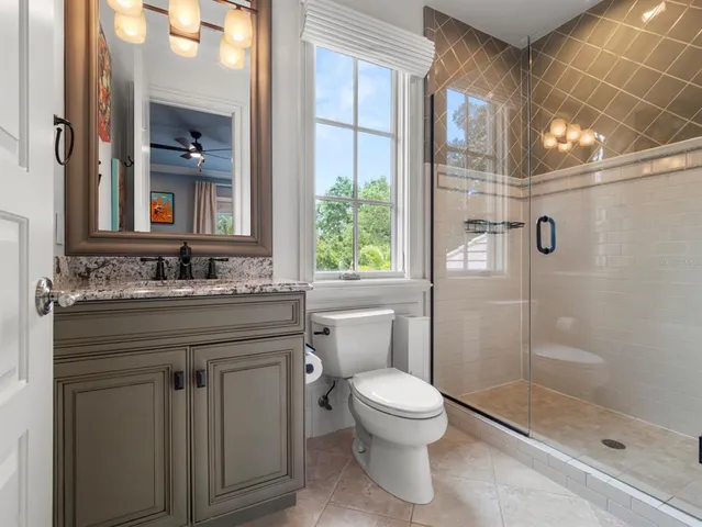a dining room with furniture and a floor to ceiling window