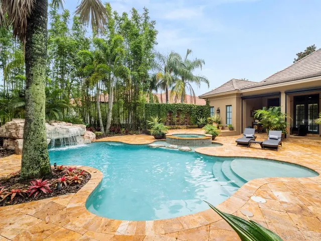 a view of a building with sitting area and garden