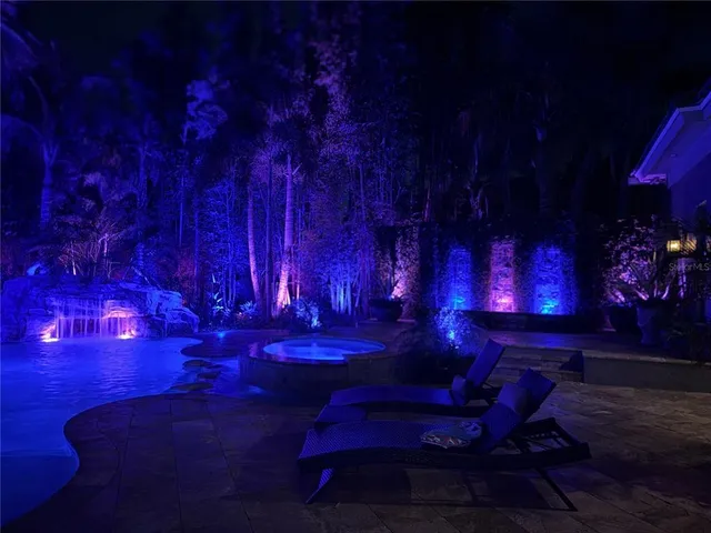 an aerial view of a house with swimming pool and garden view