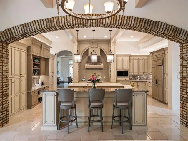 a kitchen with stainless steel appliances a sink a stove and a refrigerator