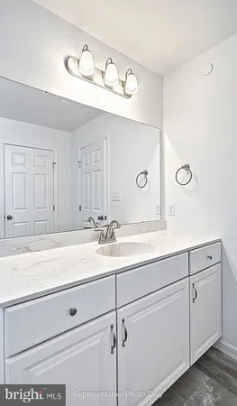 a bathroom with a sink and mirror