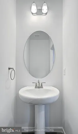a bathroom with a sink a mirror and shower