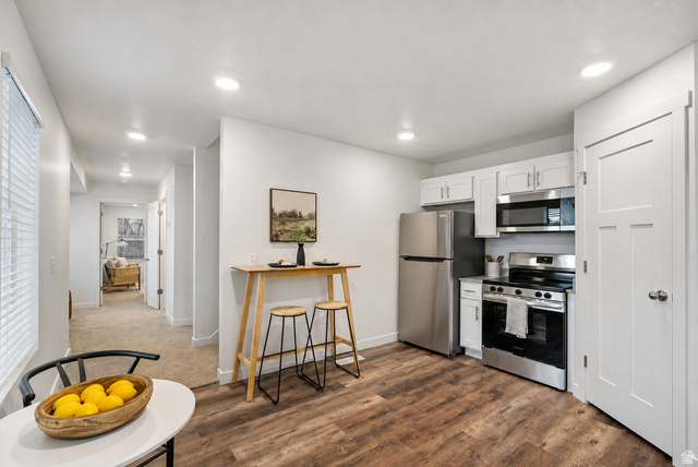 445 950 South Ogden, UT 84404 - Photo 8 of 28 Kitchen featuring stainless steel appliances, white cabinets, light countertops, dark wood finished floors, and recessed lighting
