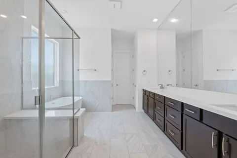a bathroom with a double vanity sink and a mirror
