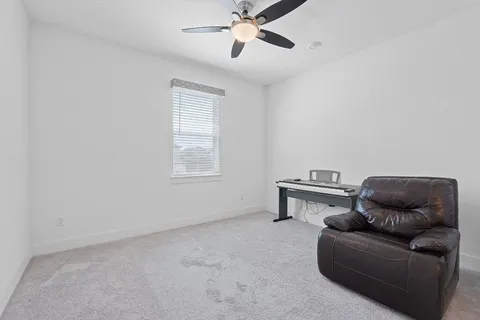 a living room with furniture and a piano