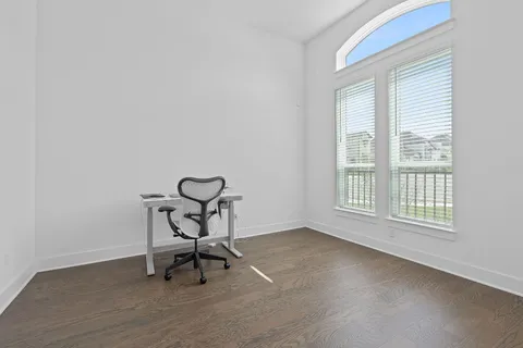 a view of a workspace with furniture and a window