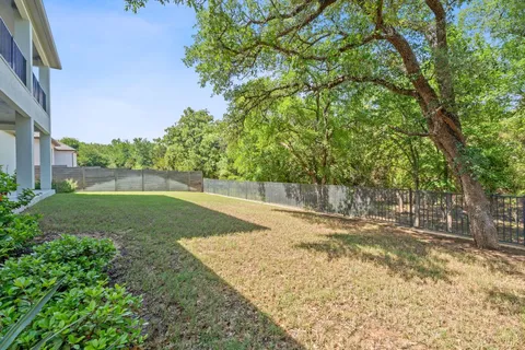a view of a backyard with large trees