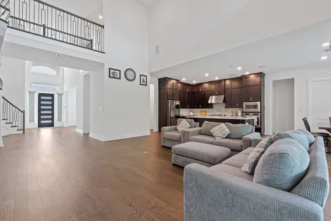 a living room with furniture and kitchen view