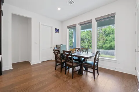 a view of a dining room with furniture and a window