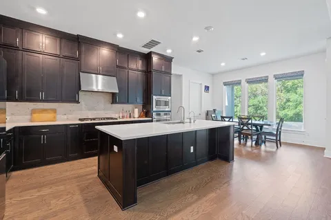 a kitchen with a sink refrigerator and cabinets