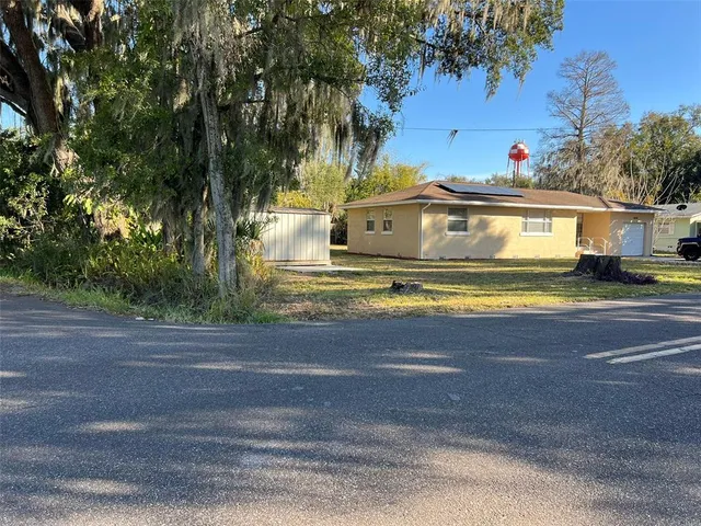 a view of street with yellow house