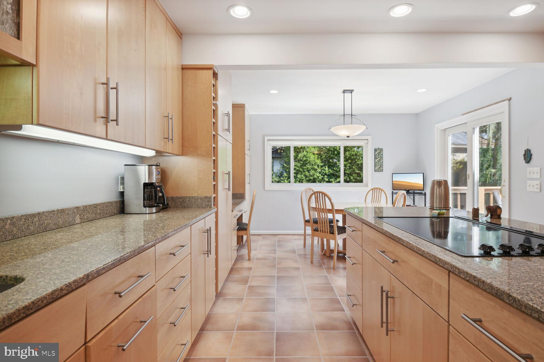 1507 Blue Meadow Road Potomac, MD 20854 - Photo 12 of 36 a large kitchen with granite countertop a large counter top space appliances and cabinets
