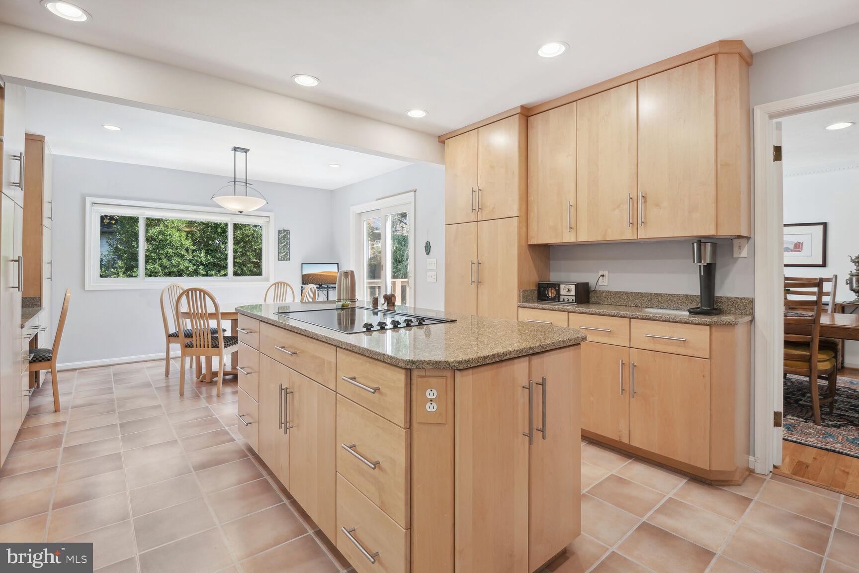 1507 Blue Meadow Road Potomac, MD 20854 - Photo 13 of 36 a kitchen with kitchen island granite countertop a sink cabinets and counter space