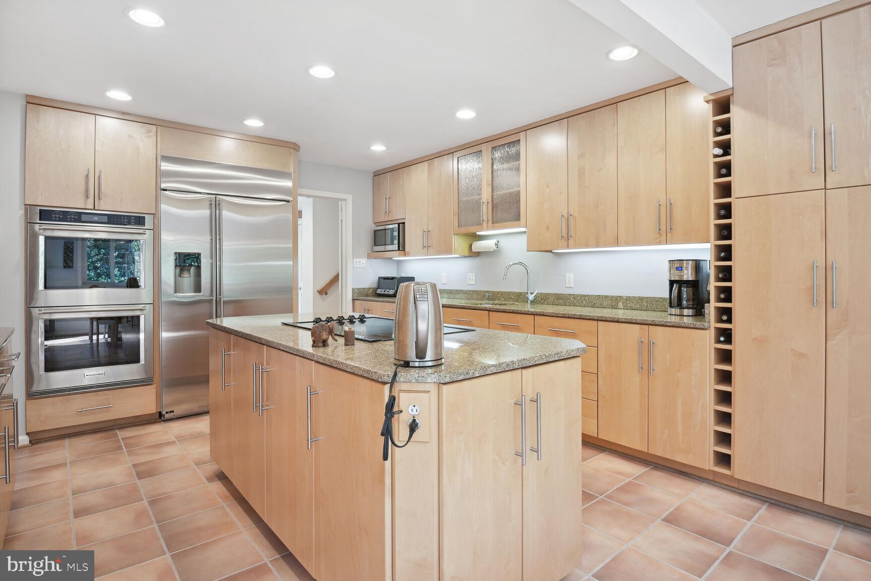 1507 Blue Meadow Road Potomac, MD 20854 - Photo 15 of 36 a kitchen with stainless steel appliances granite countertop a sink and cabinets