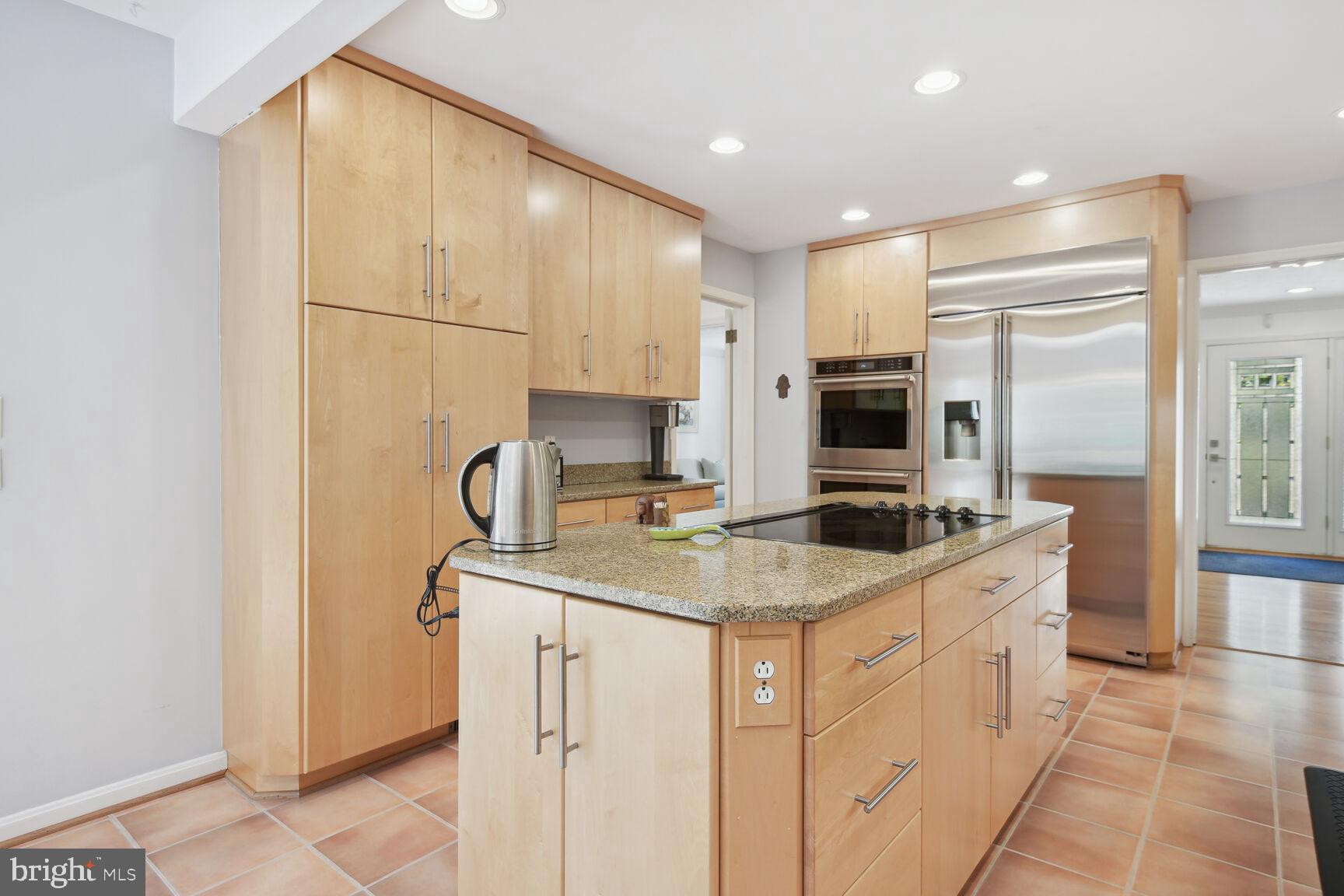 1507 Blue Meadow Road Potomac, MD 20854 - Photo 16 of 36 a kitchen with stainless steel appliances granite countertop a sink a stove and a refrigerator