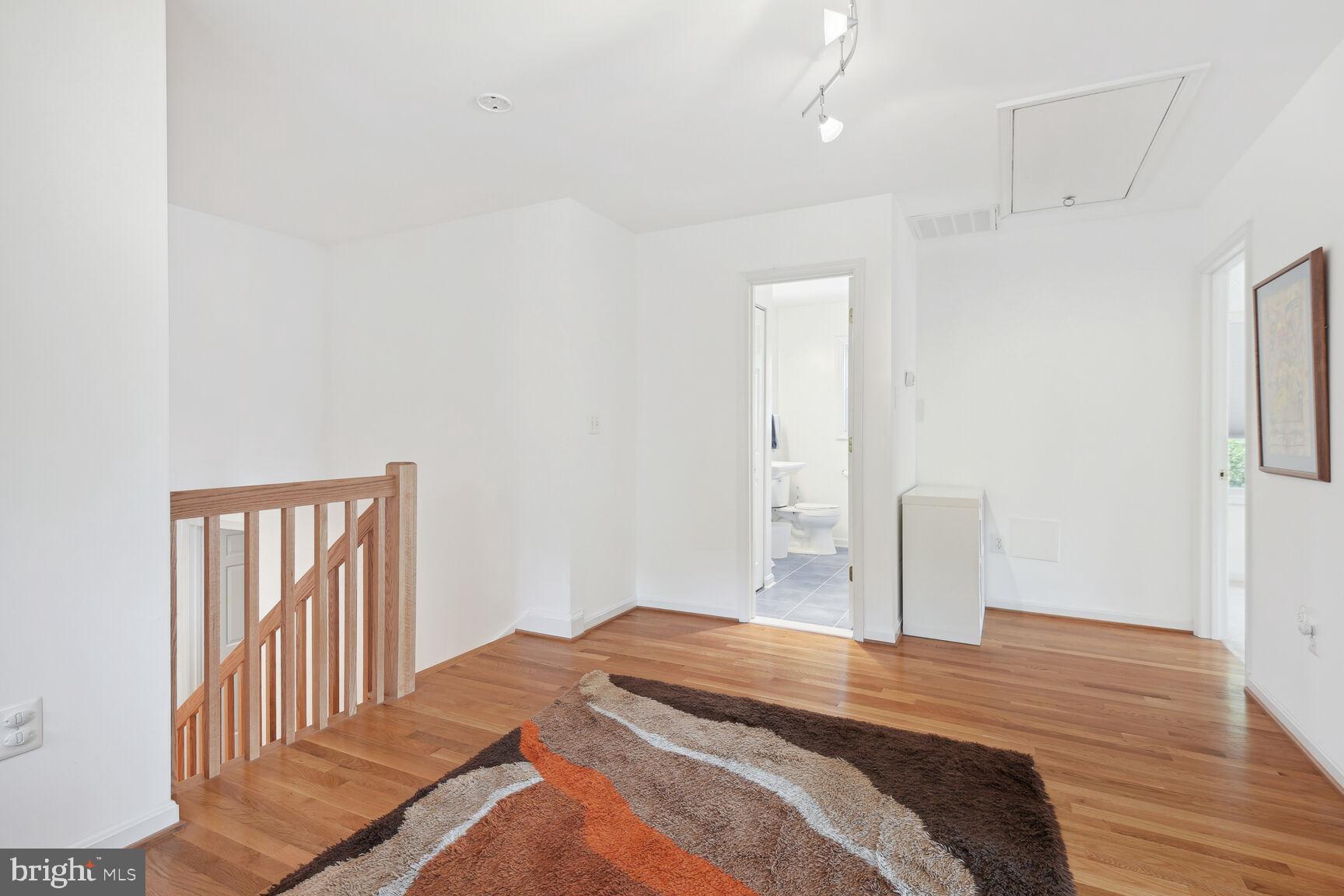 1507 Blue Meadow Road Potomac, MD 20854 - Photo 21 of 36 a bedroom with a bed and wooden floor