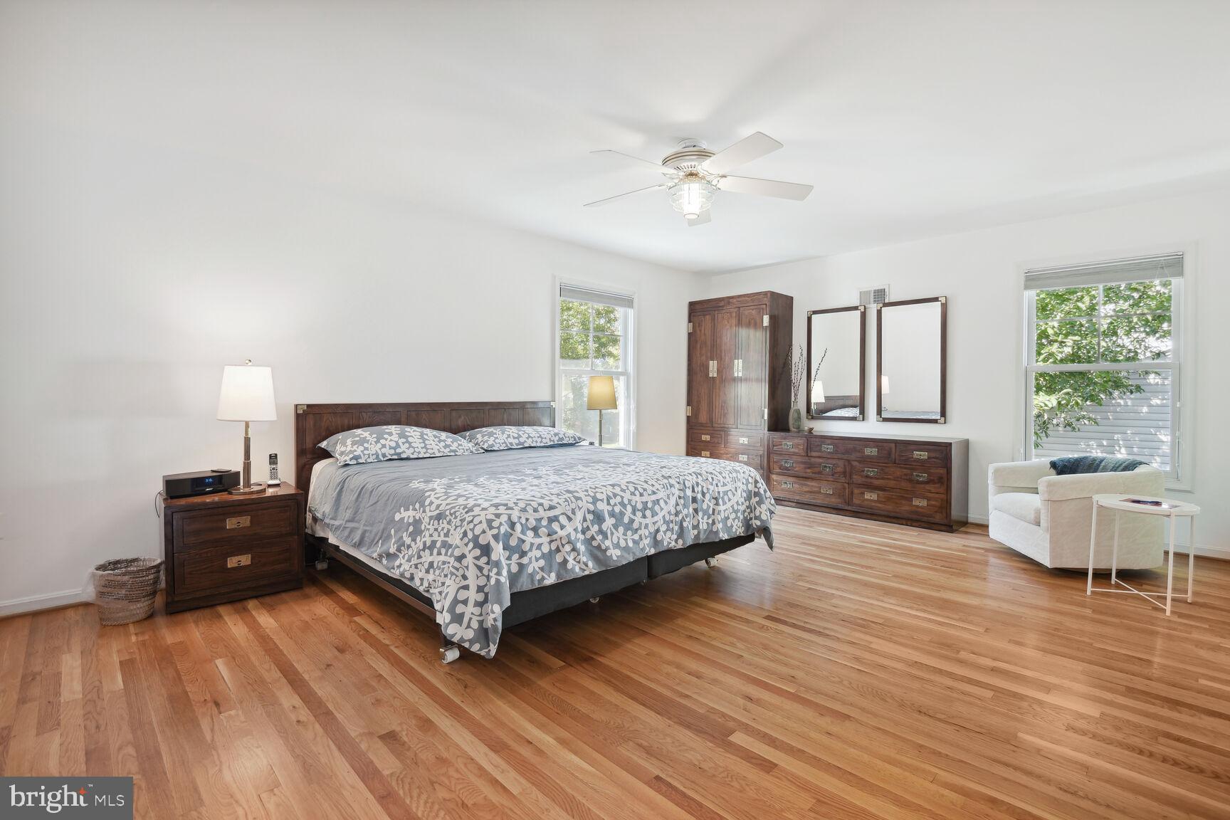 1507 Blue Meadow Road Potomac, MD 20854 - Photo 22 of 36 a spacious bedroom with a large bed and a chandelier