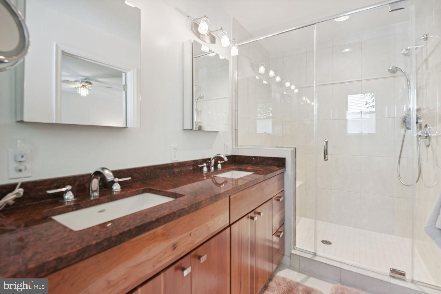 1507 Blue Meadow Road Potomac, MD 20854 - Photo 24 of 36 a bathroom with a sink double vanity granite tub and shower
