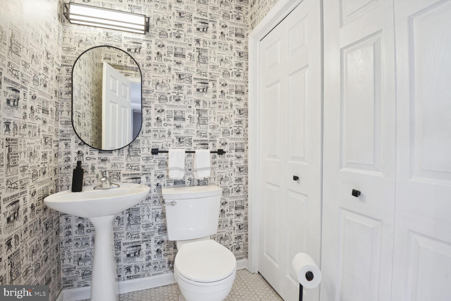 1507 Blue Meadow Road Potomac, MD 20854 - Photo 32 of 36 a bathroom with a sink a mirror a toilet and a mirror