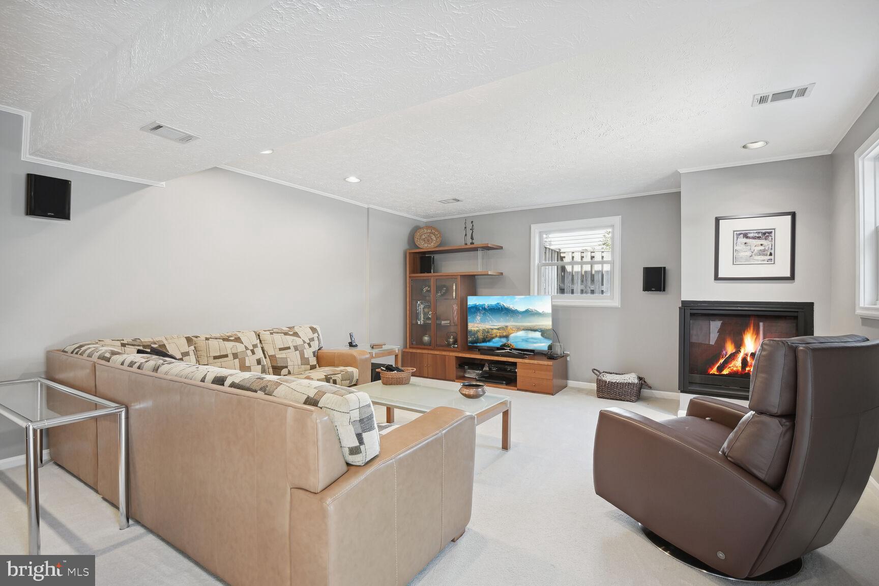 1507 Blue Meadow Road Potomac, MD 20854 - Photo 34 of 36 a living room with furniture and a flat screen tv