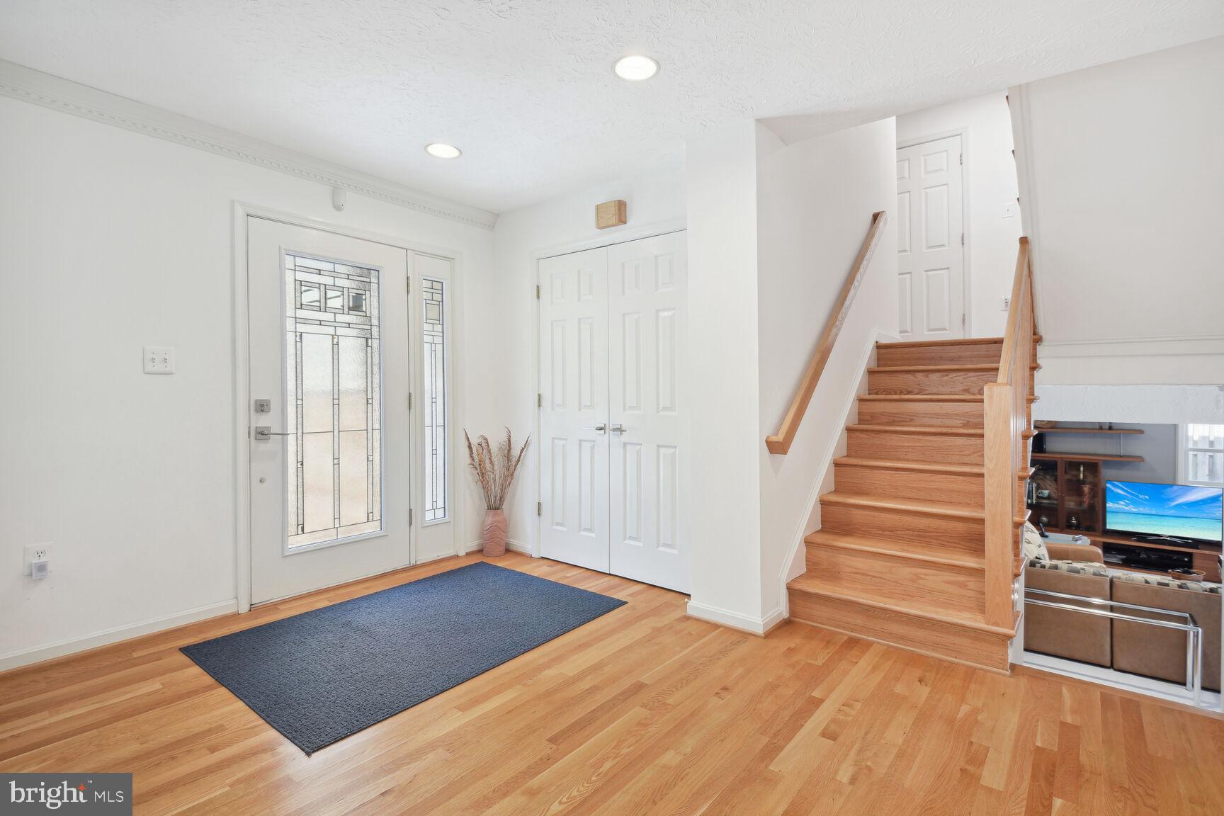 1507 Blue Meadow Road Potomac, MD 20854 - Photo 5 of 36 a view of an empty room with wooden floor and stairs