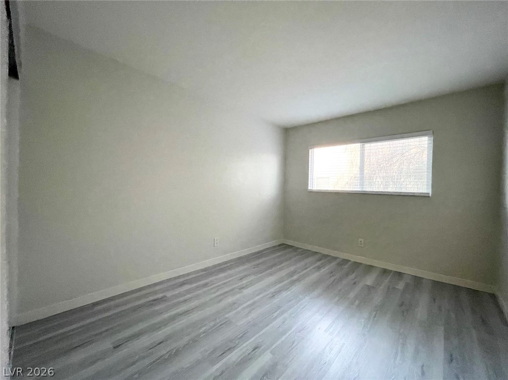 1834 North Decatur Boulevard, Unit 204 Las Vegas, NV 89108 - Photo 16 of 17 A quiet bedroom featuring resilient flooring and natural light through the window.