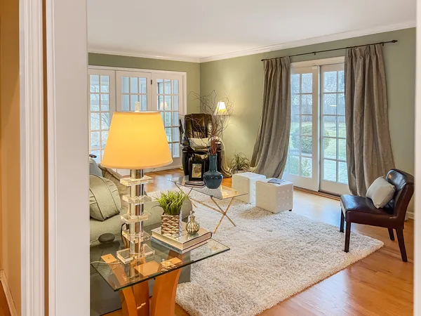 a living room with furniture and floor to ceiling windows