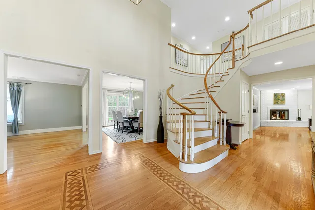 a view of an entryway with wooden floor and a livingroom view