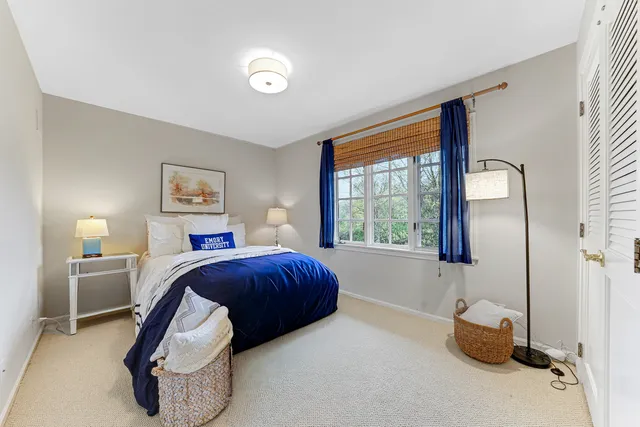 a bedroom with a bed and a painting on the wall